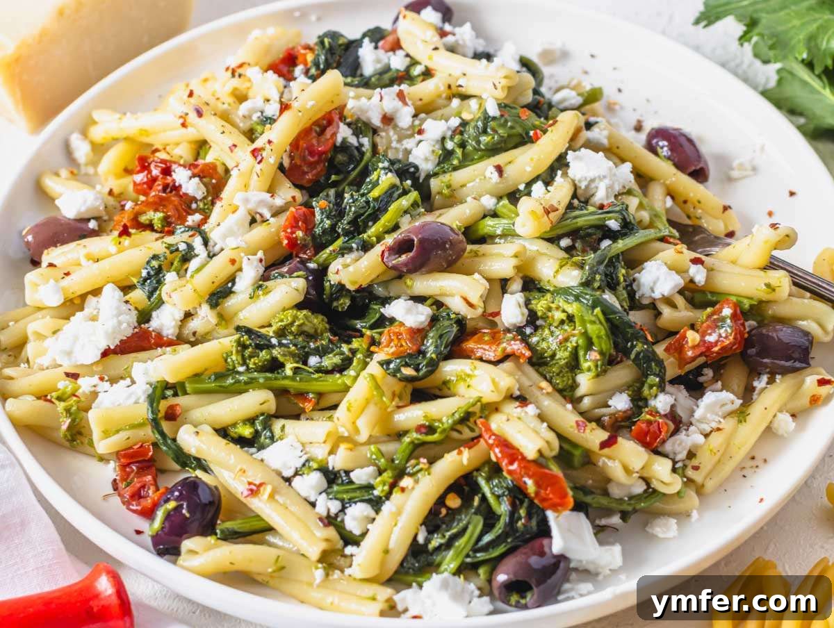 Coastal Greek Pasta Dinner 7 Step 4 Greek inspired mediterranean pasta served on a plate with crumbled feta.