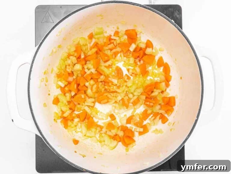 Step 1 Sautéing onion, carrot, and celery in olive oil for the soup base.