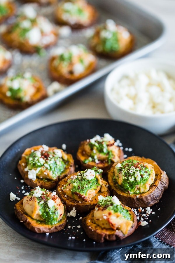 Vibrant Pesto Hummus Sweet Potato Rounds 3 A plate of Pesto Hummus Sweet Potato Bites ready to serve, showcasing the colorful layers of ingredients.