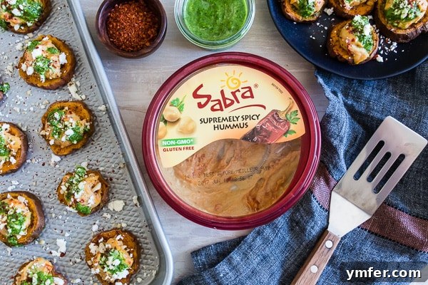 Vibrant Pesto Hummus Sweet Potato Rounds 5 A close-up view of a single Pesto Hummus Sweet Potato Bite, highlighting the texture of the roasted sweet potato and creamy toppings.