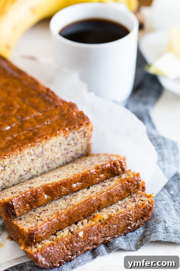 Island Escape Banana Bread with Coconut Rum and Zesty Lime Glaze 2 Sliced Coconut Rum Lime Glazed Banana Bread on a rustic wooden table, showcasing its moist interior and glistening glaze.
