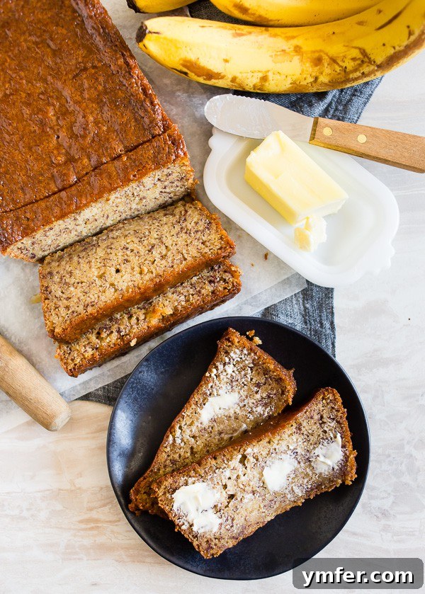 Island Escape Banana Bread with Coconut Rum and Zesty Lime Glaze 3 A slice of Coconut Rum Lime Glazed Banana Bread generously spread with butter, ready to be enjoyed.