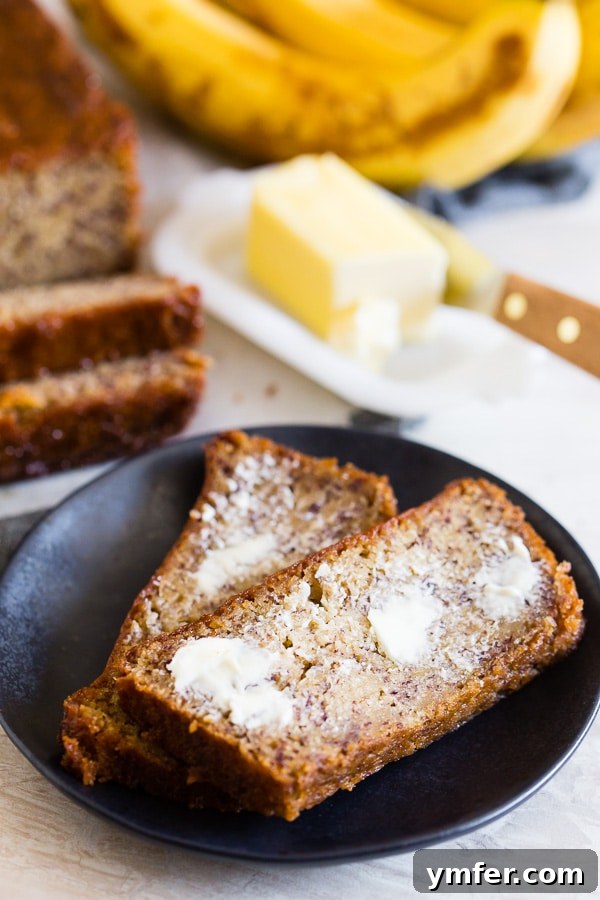Island Escape Banana Bread with Coconut Rum and Zesty Lime Glaze 5 A slice of Coconut Rum Lime Glazed Banana Bread served alongside a pat of butter, emphasizing its appealing presentation.