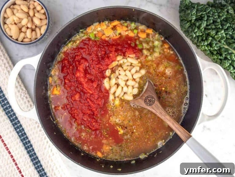 Heart-Smart Mediterranean Kale Soup 11 Step 2 Adding crushed tomatoes, beans, and broth into the pot for healthy Mediterranean kale soup.