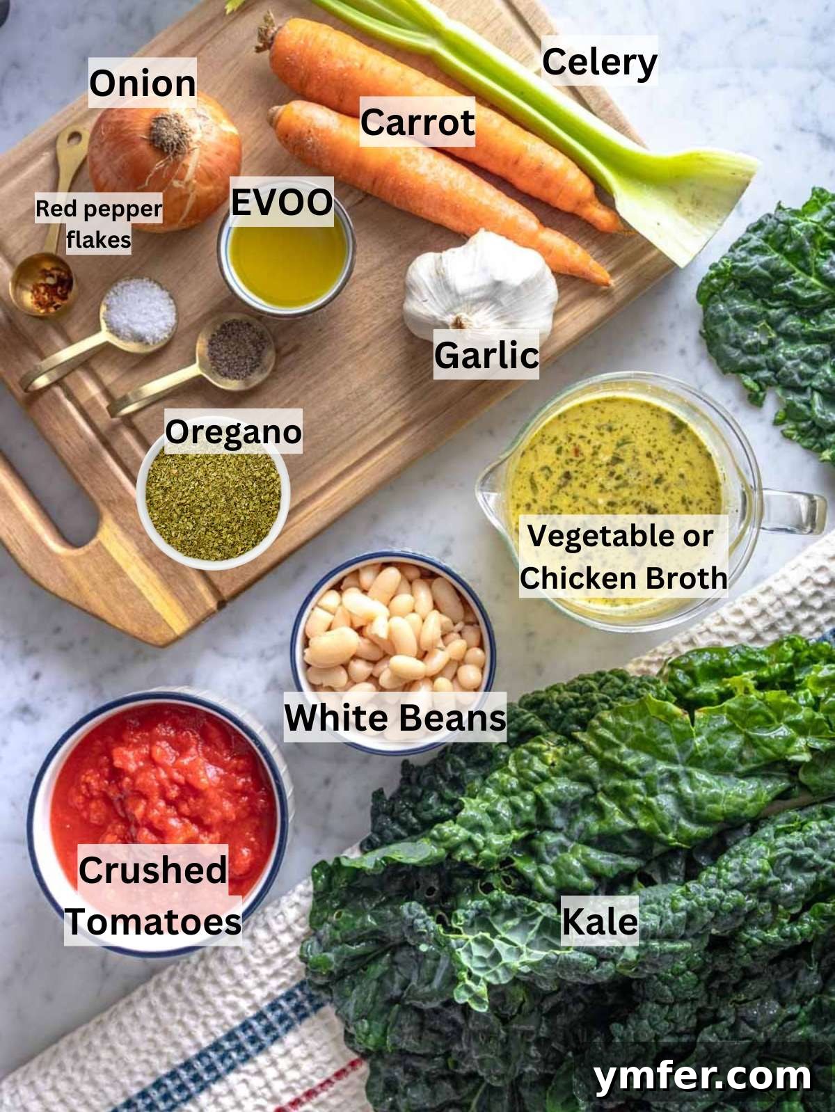 Heart-Smart Mediterranean Kale Soup 3 Fresh ingredients for Mediterranean kale soup with kale, white beans, and tomatoes on a table.