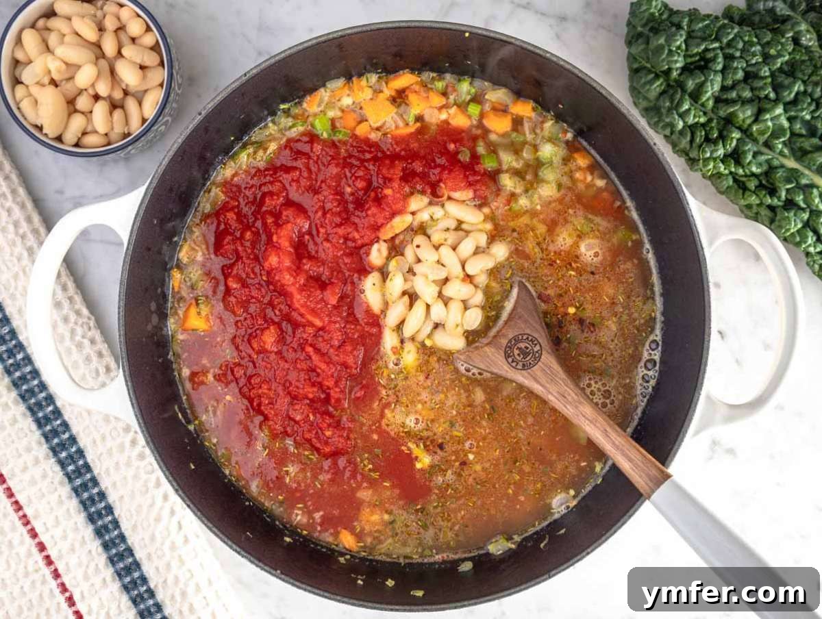 Heart-Smart Mediterranean Kale Soup 6 Step 2 Adding crushed tomatoes, beans, and broth into the pot for healthy Mediterranean kale soup.