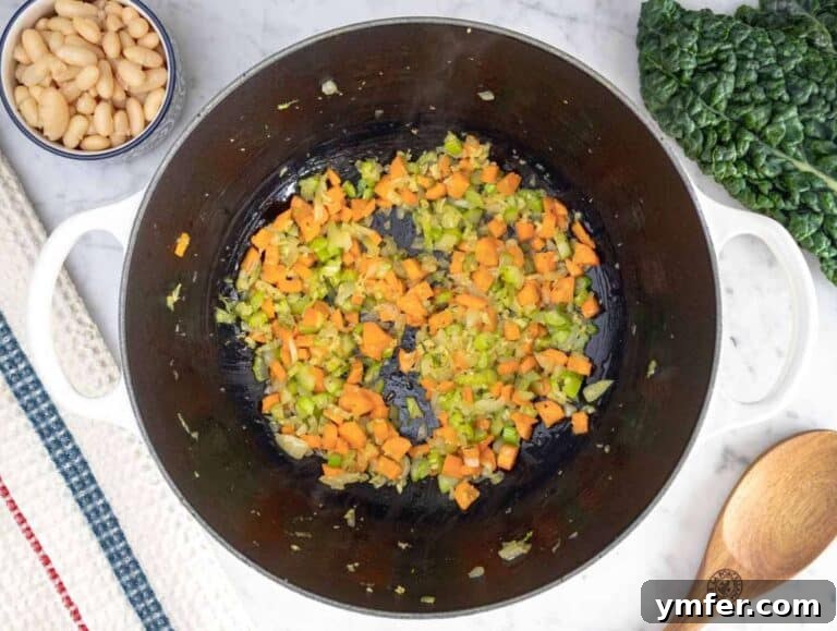 Heart-Smart Mediterranean Kale Soup 10 Step 1 Sautéing onion, carrot, and celery in olive oil for Mediterranean kale soup flavor base.