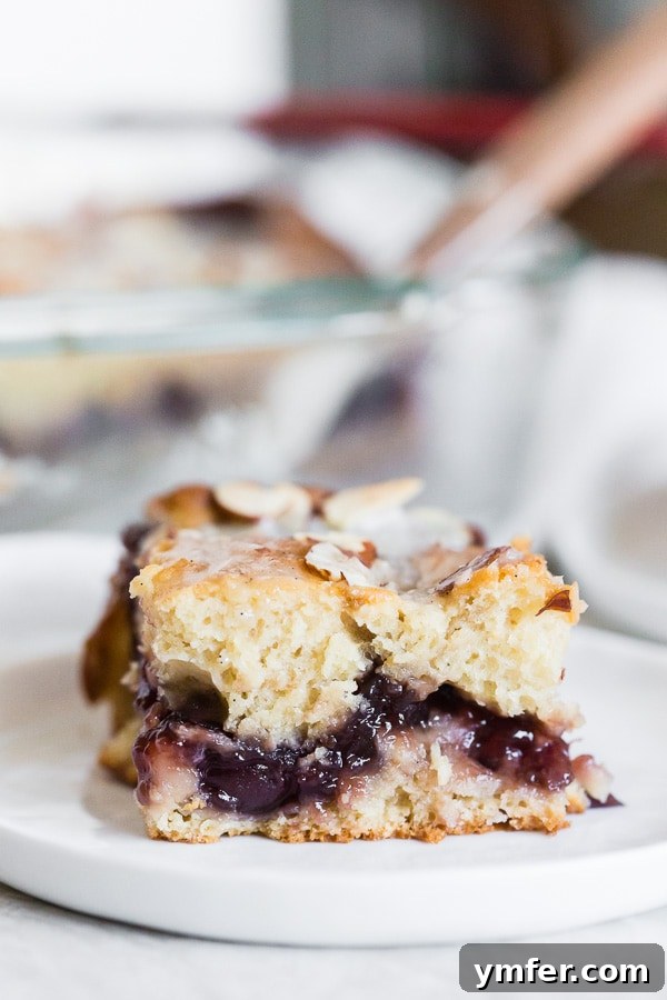 Old-Fashioned Cherry Fritter Cake 2 Cherry Fritter Cake sliced to show the inside cherry layer.