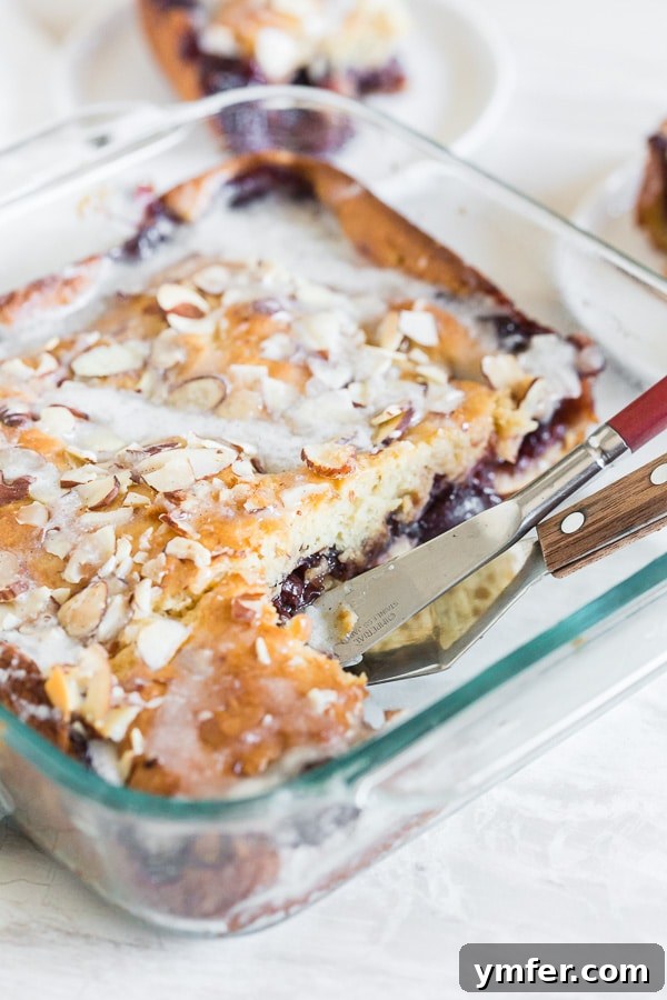 Old-Fashioned Cherry Fritter Cake 4 Cherry Fritter Cake sliced in a 9x9 glass dish.