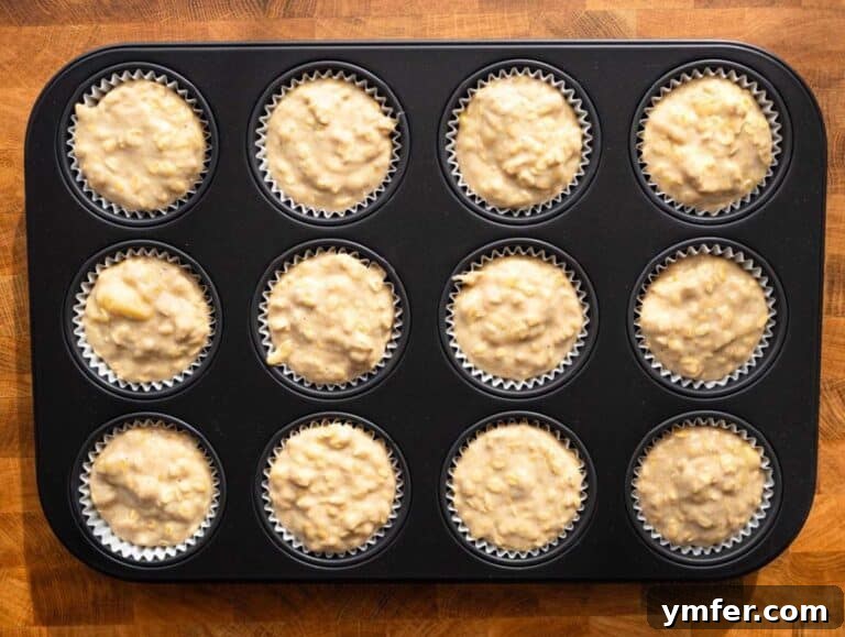 Step 3 Filling muffin pan with banana oatmeal batter before baking.