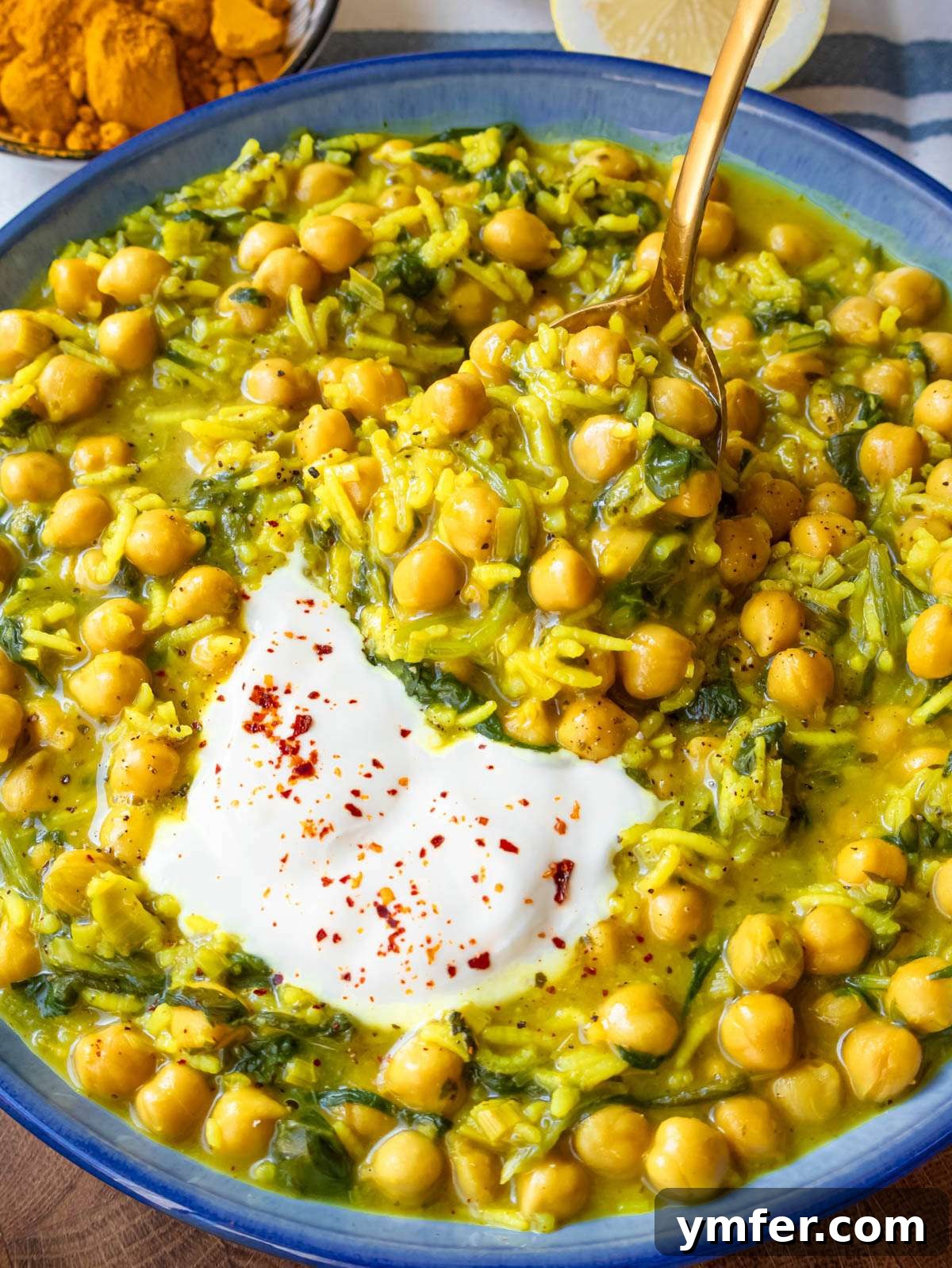 Golden Turmeric Chickpea Rice 2 Close up of creamy turmeric rice with chickpeas spinach and Greek yogurt for a wholesome meal.