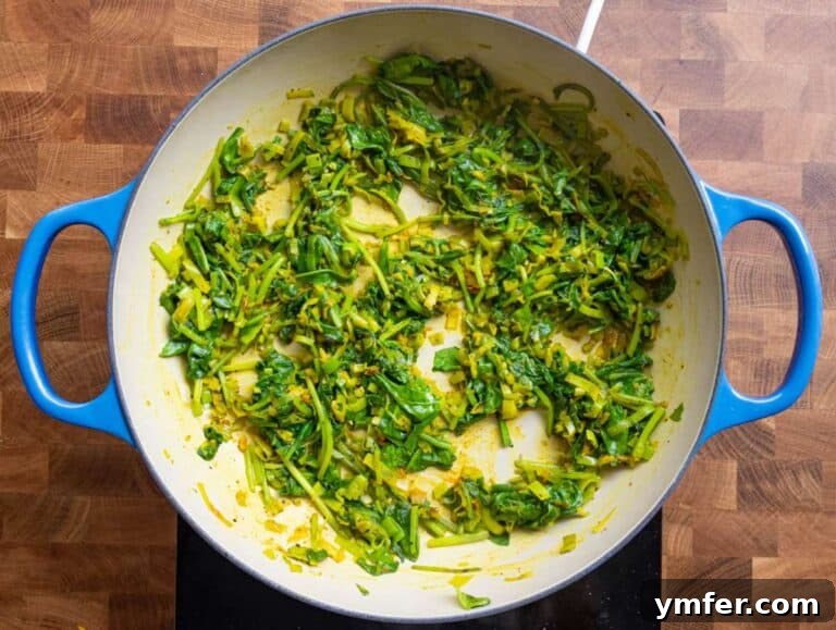 Golden Turmeric Chickpea Rice 11 Step 2 Adding turmeric oregano and spinach to the pan for a colorful anti inflammatory vegetarian dinner.