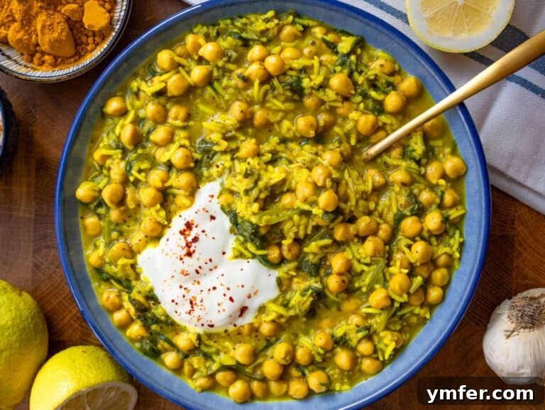 Golden Turmeric Chickpea Rice 13 Step 4 Finished turmeric rice with chickpeas and spinach topped with Greek yogurt and lemon ready to serve.