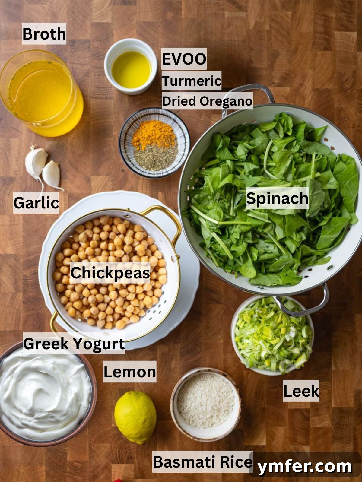 Golden Turmeric Chickpea Rice 3 Fresh ingredients for turmeric rice including leek garlic chickpeas spinach turmeric and rice on a table.