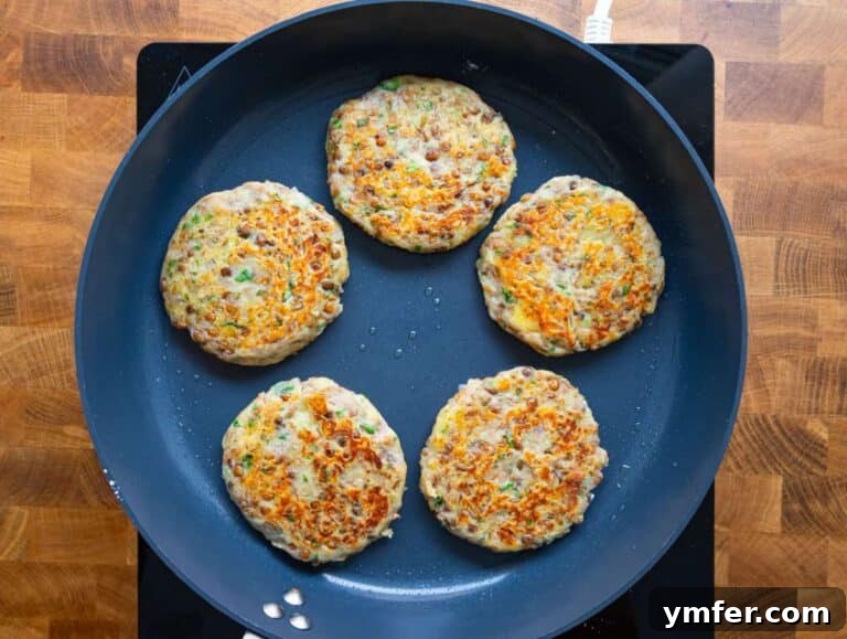Step 3: Lentil potato patties sizzling in a nonstick skillet, developing a golden-brown and crispy crust.