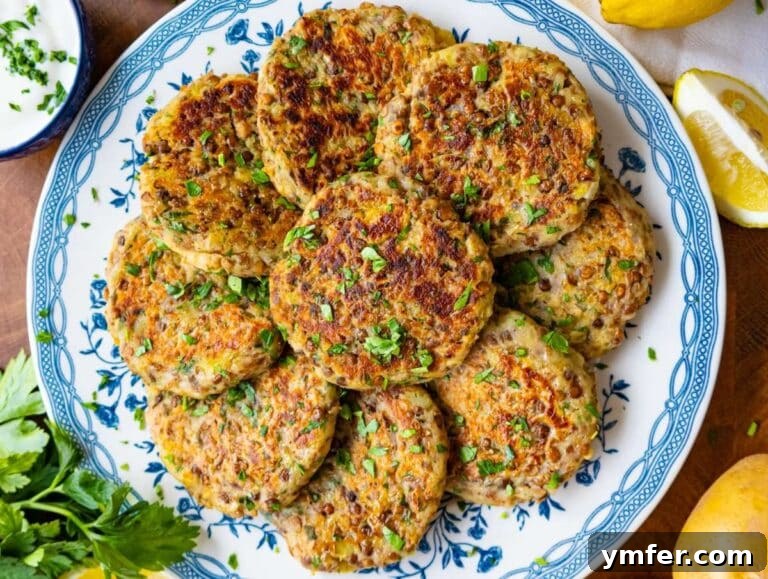 Step 4: A beautifully plated serving of warm lentil potato patties, accompanied by a dollop of Greek yogurt and a sprinkle of fresh parsley, embodying a light and healthy Mediterranean meal.