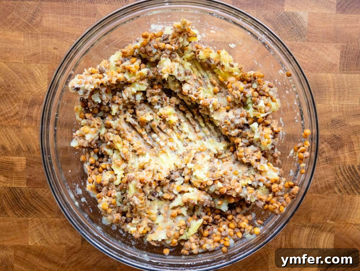 Step 1: Mashed potato and thoroughly rinsed, drained lentils combined in a large mixing bowl, forming the base for the patties.