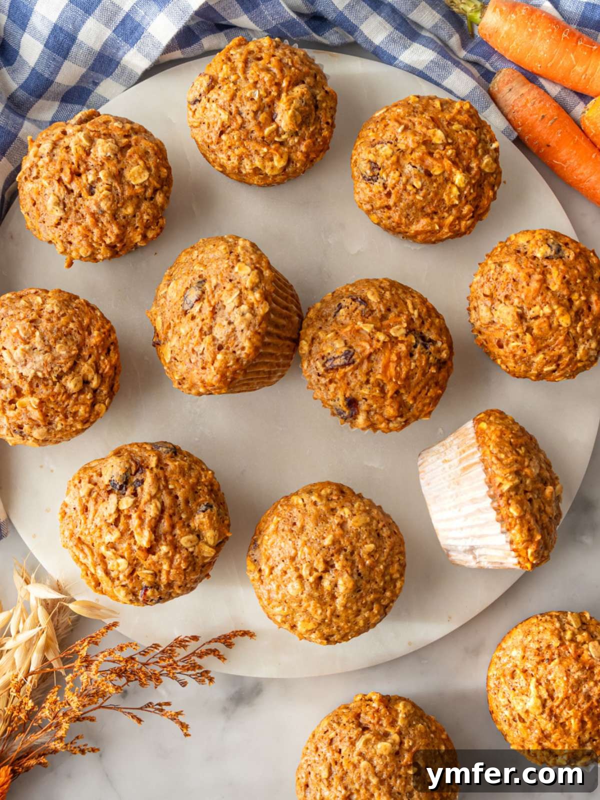 Smart Start Carrot Muffins 2 Freshly baked oil free carrot muffins displayed on a marble table for wholesome morning treat.
