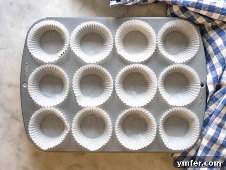 Step 1 lined muffin pan ready for oil free carrot cake batter.