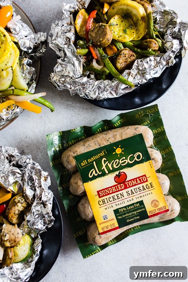 Hearty Chicken Sausage and Roasted Veggie Foil Bundles 3 A close-up of the chicken sausage and vegetables nestled in a foil packet, ready for cooking.