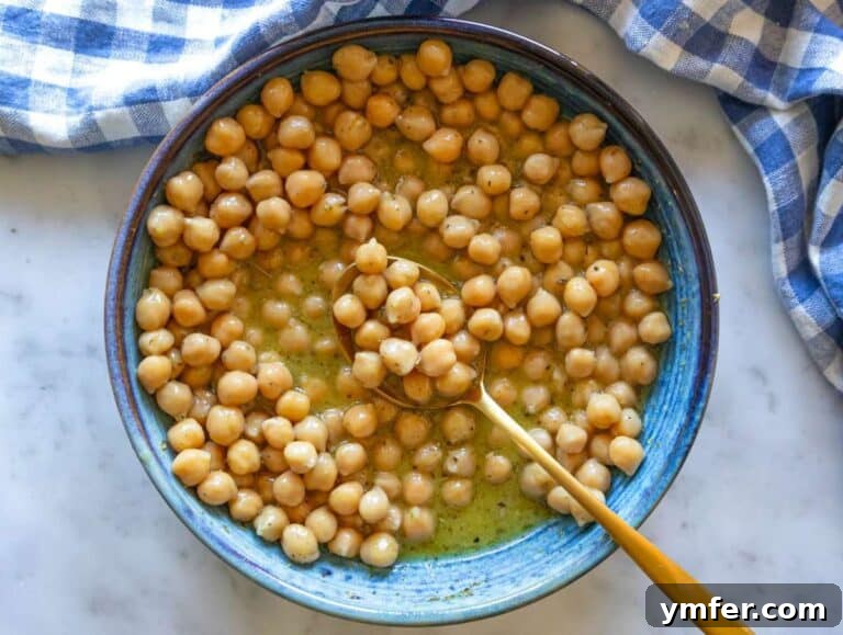Nourishing Sweet Potato Chickpea Salad 12 Step 3: Chickpeas marinating in honey mustard dressing for rich Mediterranean flavor.