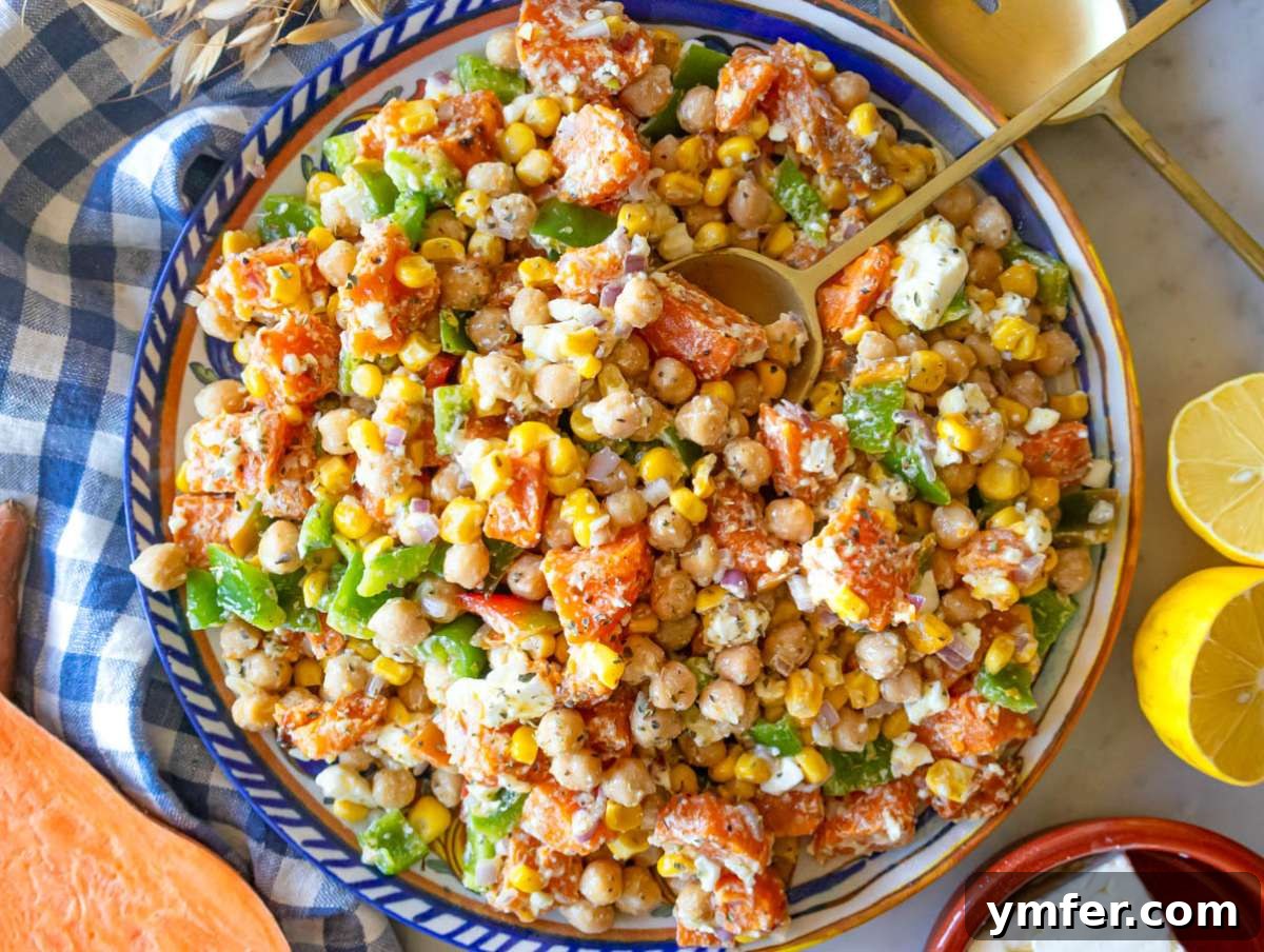 Nourishing Sweet Potato Chickpea Salad 8 Step 4: Serving dense sweet potato salad with chickpeas, assorted veggies, and crumbled feta on a platter, ready to eat.