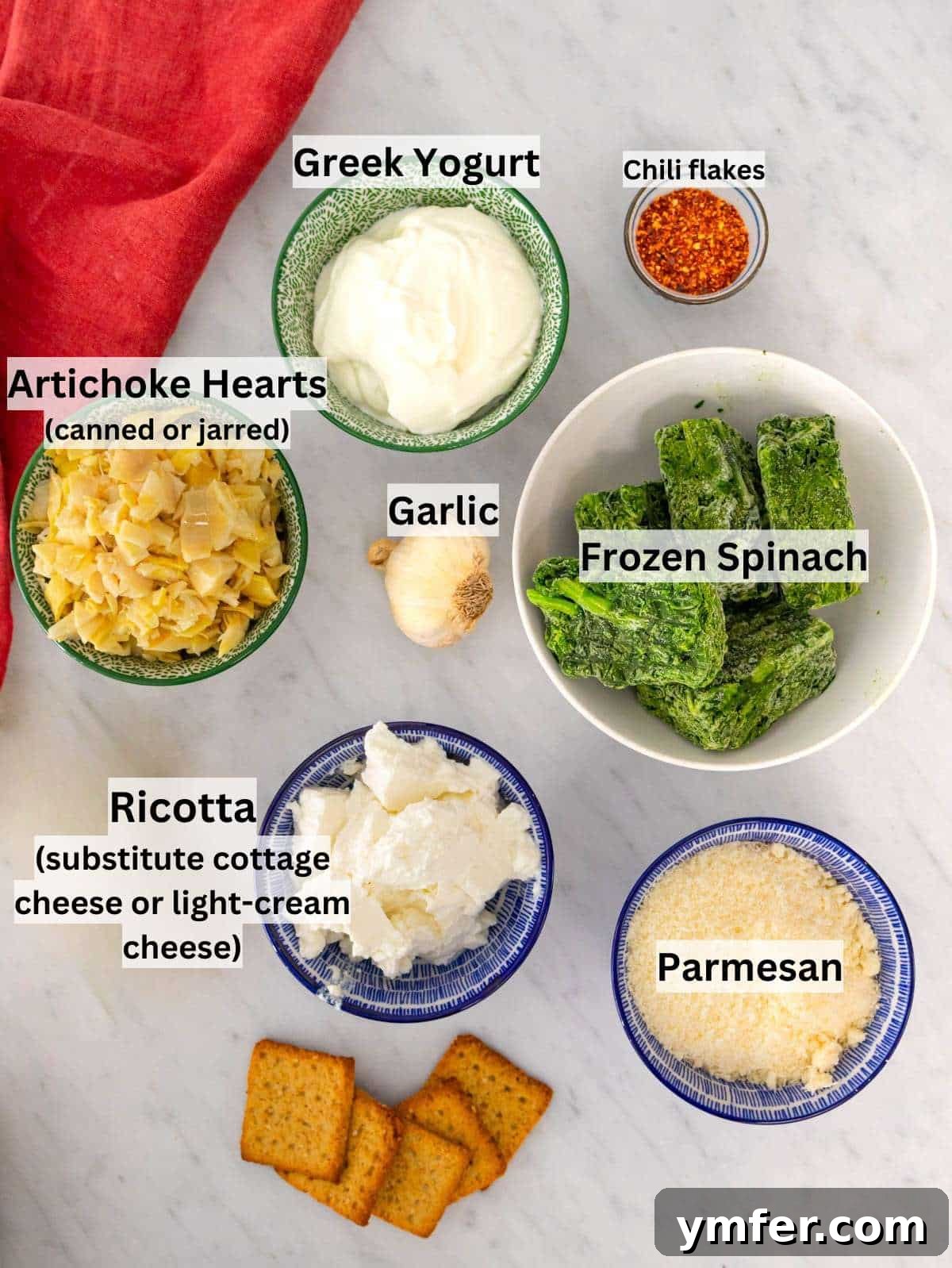 Ingredients arranged neatly for healthy spinach artichoke dip preparation.