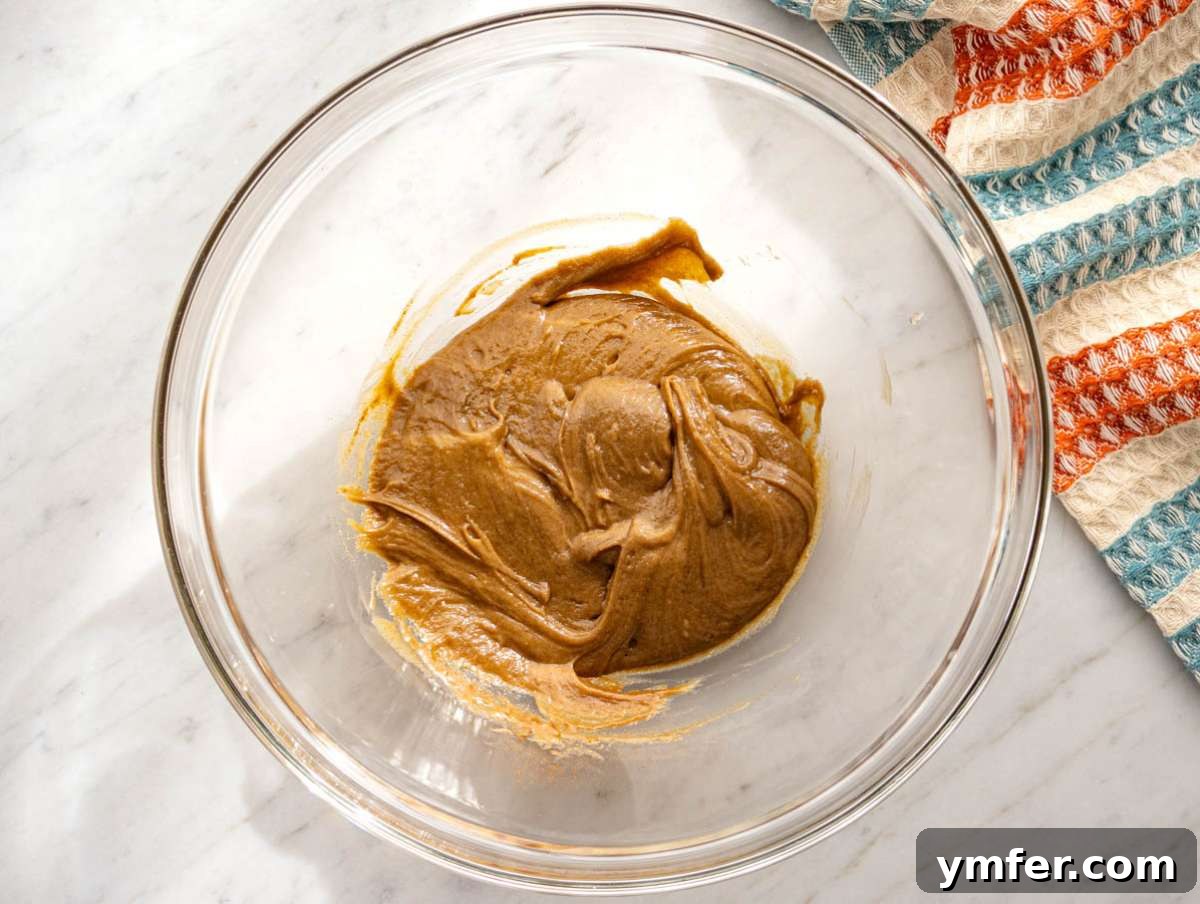 Wholesome & Crispy Granola: Oil-Free Clusters Done Right 5 Step 1 Wet ingredients mixed together with almond butter honey vanilla and cinnamon in a large bowl.