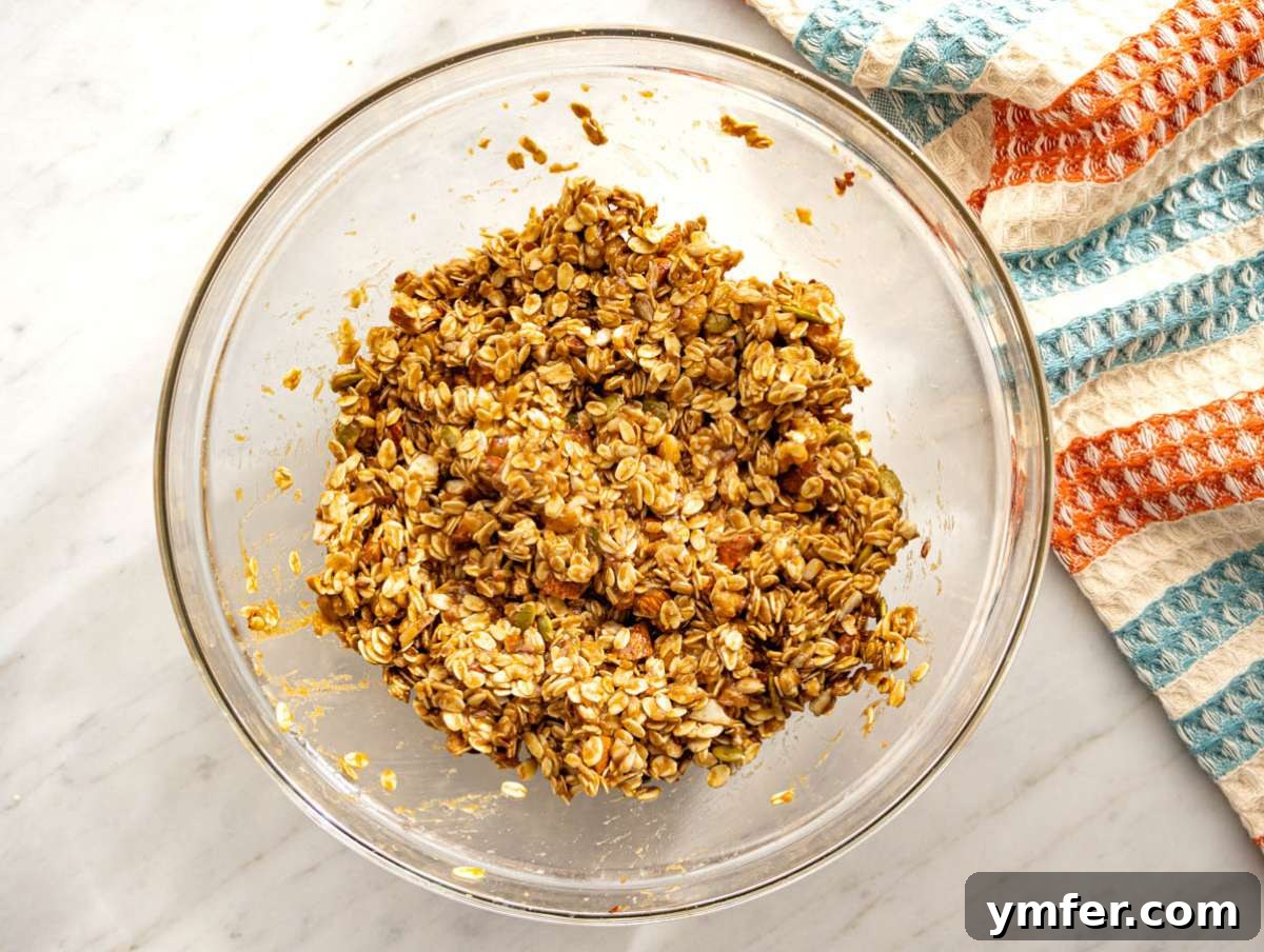 Wholesome & Crispy Granola: Oil-Free Clusters Done Right 6 Step 2 Oats nuts and seeds stirred together until evenly coated for crunchy granola clusters.