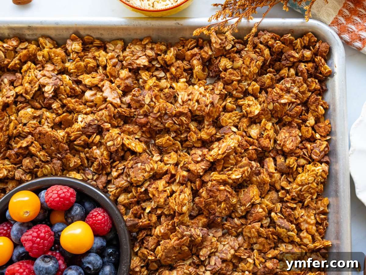 Wholesome & Crispy Granola: Oil-Free Clusters Done Right 8 Step 4 Granola cooling on sheet pan to crisp up before storing for a healthy breakfast.