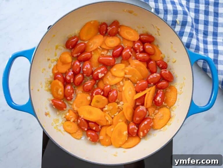 Mediterranean Orzo with Beans A Wholesome One-Pan Meal 11 Step 1 sautéing onion carrot and tomatoes until soft for flavorful base.