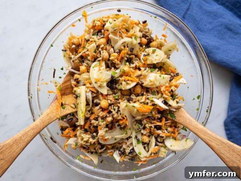 Mediterranean Wild Rice Salad for Healthy Meal Prep 12 Step 3 chopped vegetables for wild rice salad in a mixing bowl with dressing and chickpeas.