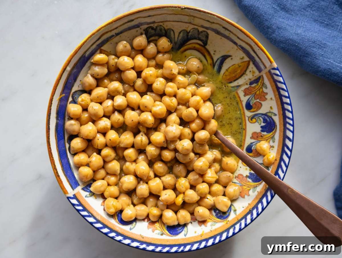 Mediterranean Wild Rice Salad for Healthy Meal Prep 6 Step 2 chickpeas soaking in citrus dressing for extra flavor.