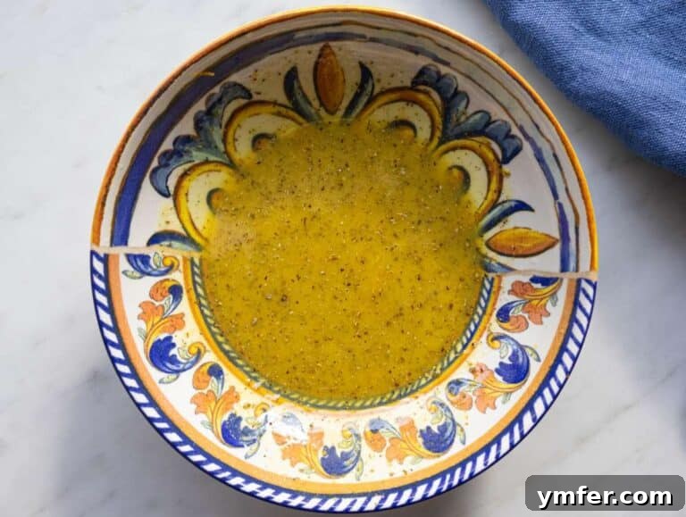Mediterranean Wild Rice Salad for Healthy Meal Prep 10 Step 1 whisking citrus mustard and olive oil to make bright Mediterranean dressing.