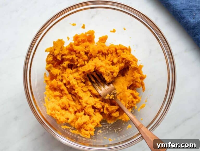 Wholesome Oil-Free Sweet Potato Oatmeal Muffins 11 Step 1 Mashed sweet potatoes in a bowl ready for baking sweet potato oat muffins.