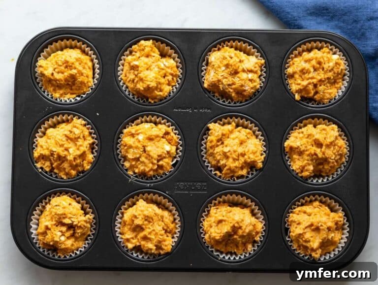 Wholesome Oil-Free Sweet Potato Oatmeal Muffins 14 Step 4 Muffin batter spooned into lined tray ready for baking.
