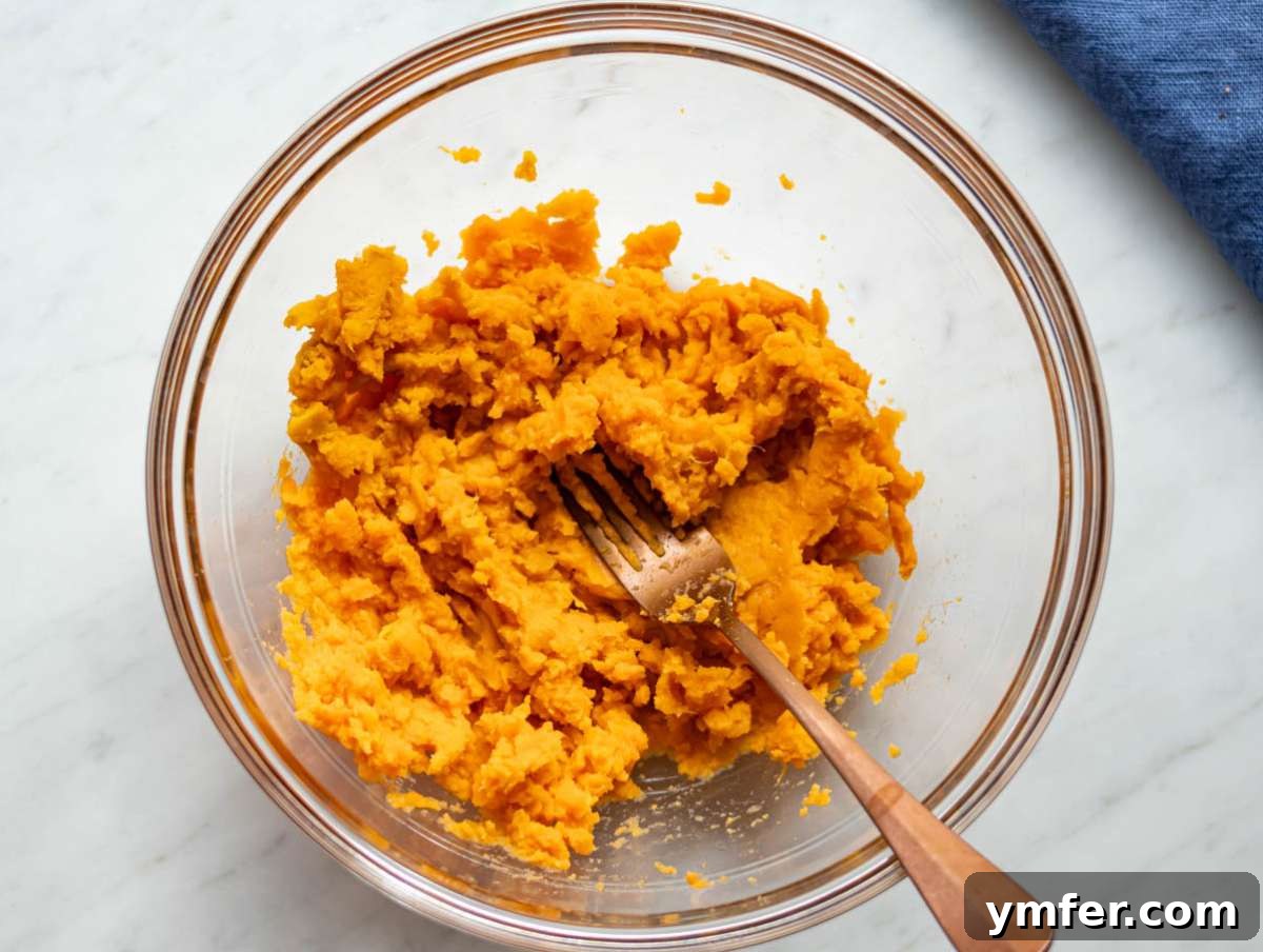 Wholesome Oil-Free Sweet Potato Oatmeal Muffins 5 Step 1 Mashed sweet potatoes in a bowl ready for baking sweet potato oat muffins.