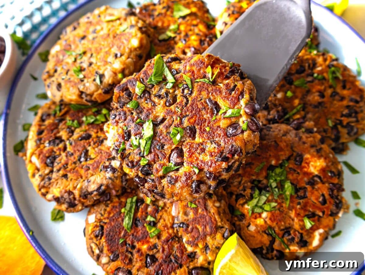 Fuel Up Fast: 25 High-Protein Bean Recipes in 30 Minutes 20 Black bean patties with feta and herbs served on a plate with lemon.