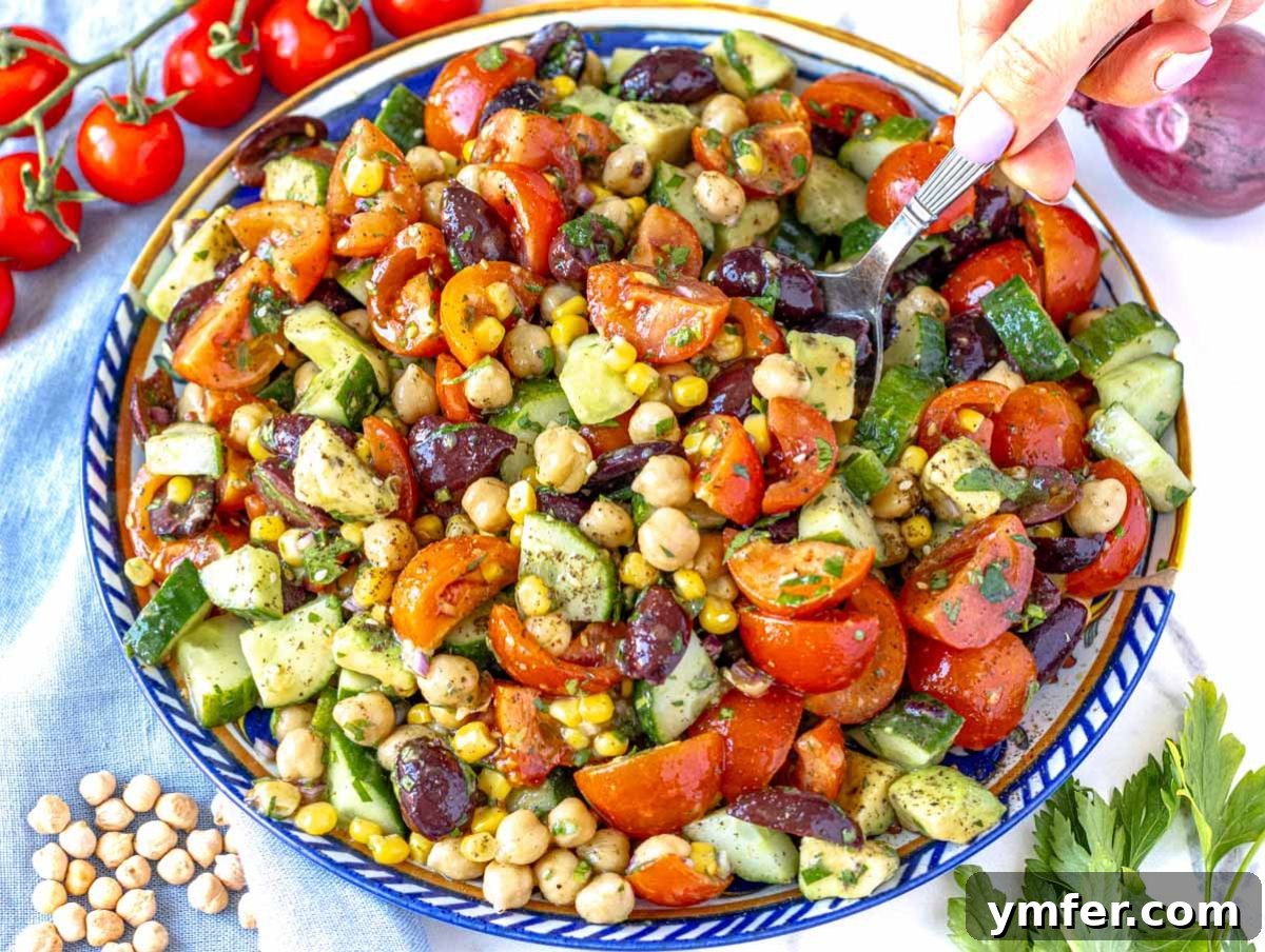 Fuel Up Fast: 25 High-Protein Bean Recipes in 30 Minutes 24 Healthy chickpea cucumber salad on a summer table with lemon and olive oil dressing.