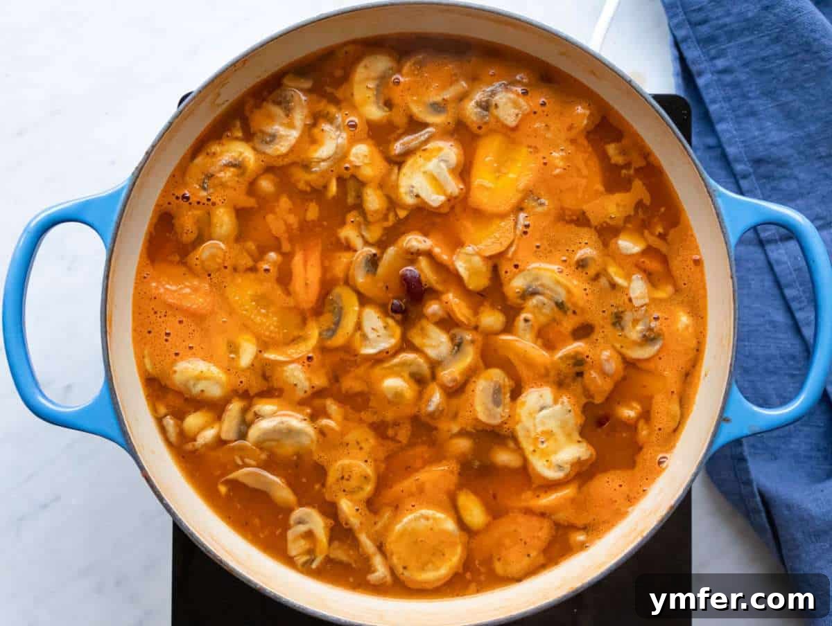 Healthy Mediterranean One-Pot Three Bean Orzo Soup 7 Step 3 Step simmering beans broth and vegetables for hearty Mediterranean orzo soup.