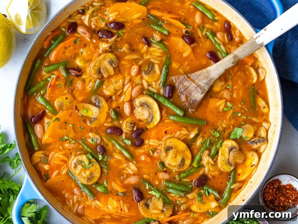 Healthy Mediterranean One-Pot Three Bean Orzo Soup 8 Step 4 Step adding green beans and orzo to pot for creamy Mediterranean soup.
