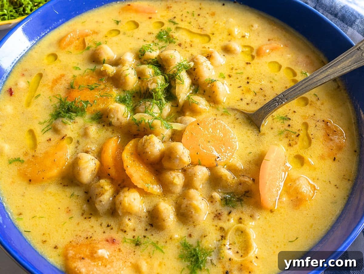 25 Affordable and Healthy Mediterranean Diet Meals 3 Bowl of Greek chickpea soup Revithia with dill olive oil and a spoon.