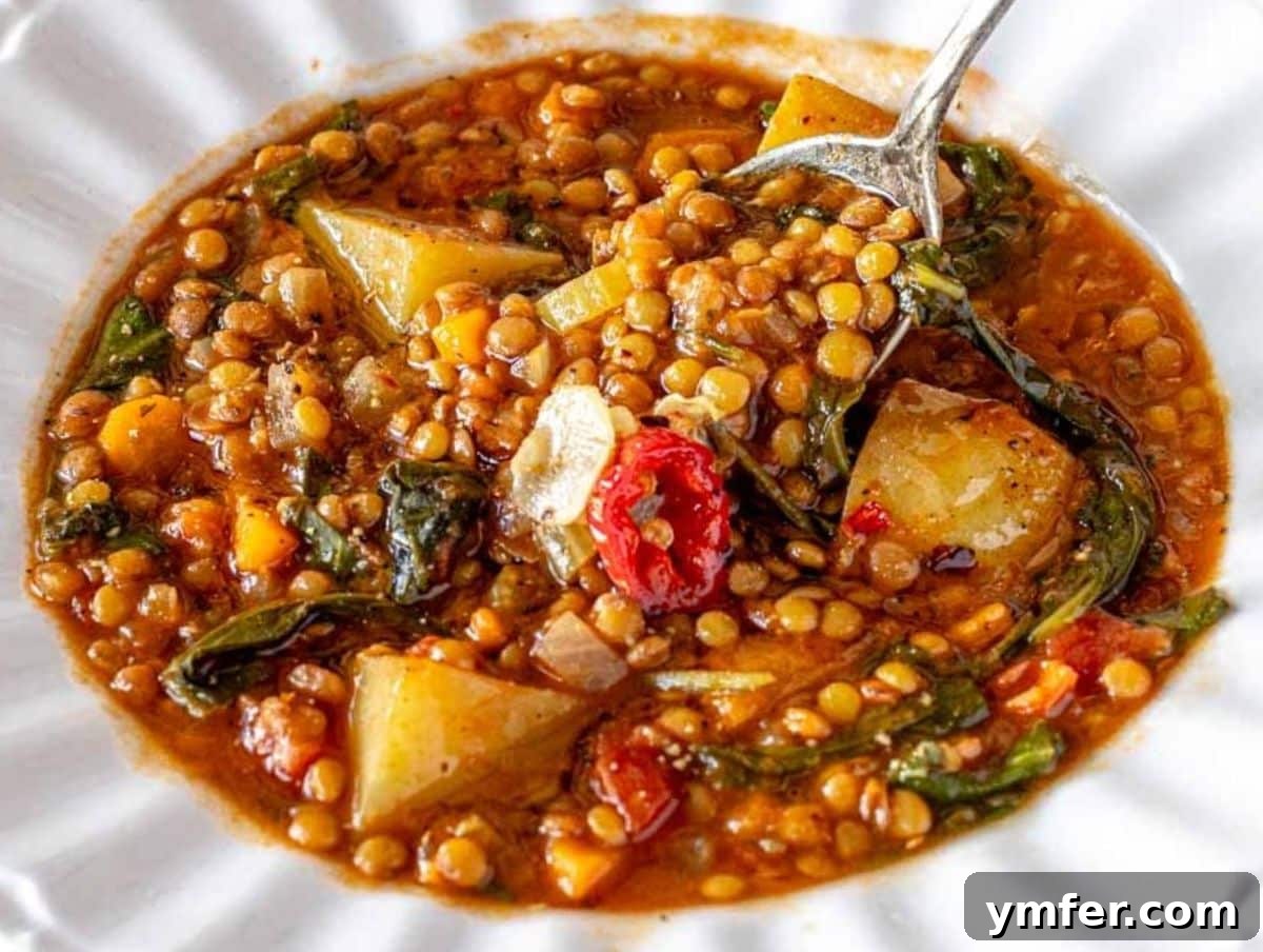 25 Affordable and Healthy Mediterranean Diet Meals 4 Healthy Budget Mediterranean lentil soup with crusty bread and fresh spinach in white bowl