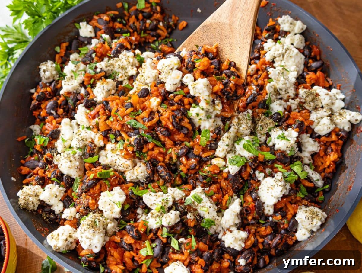 25 Affordable and Healthy Mediterranean Diet Meals 7 Healthy black beans and rice in skillet showcasing vibrant colors and creamy marinated feta.