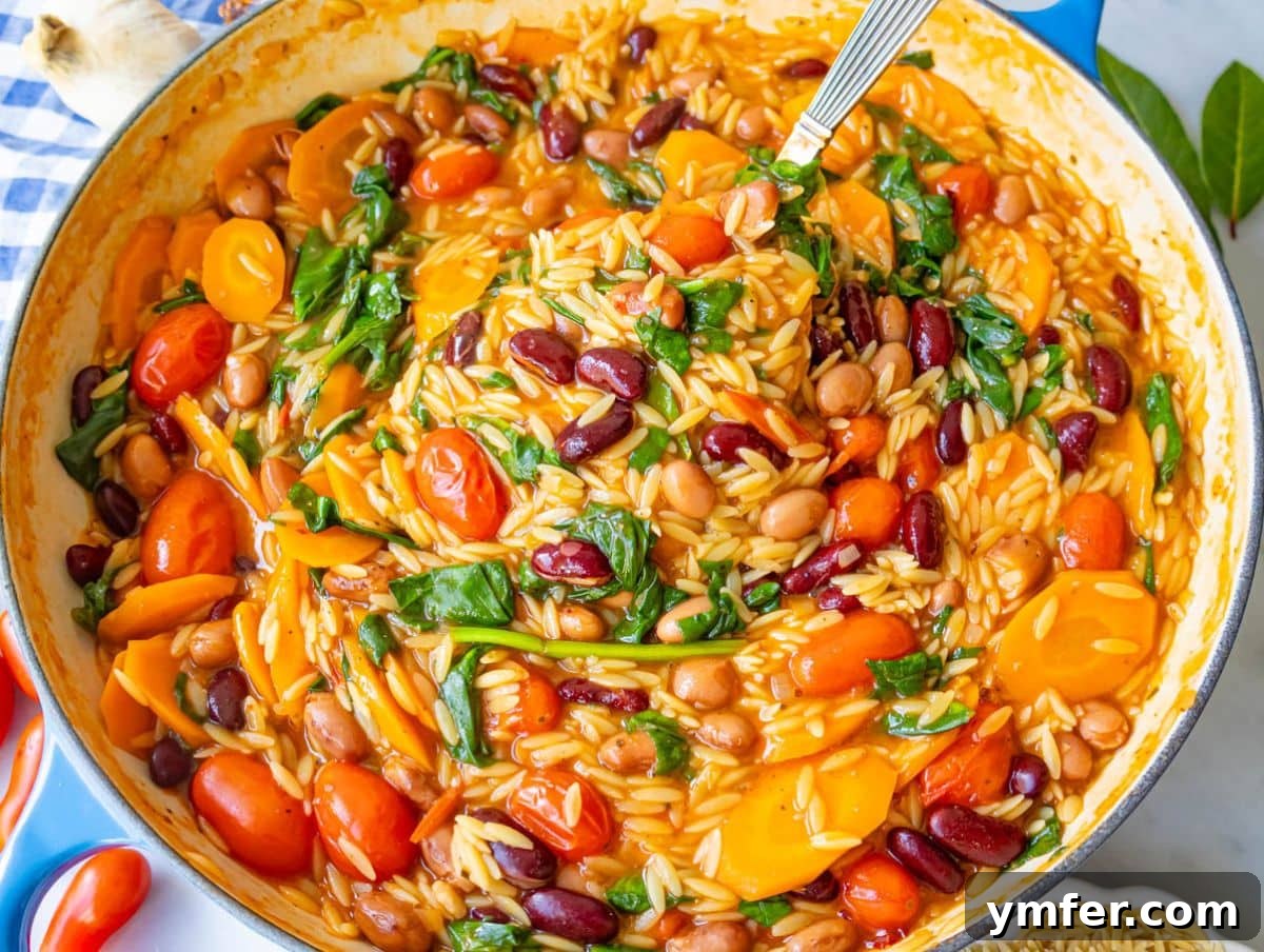 25 Affordable and Healthy Mediterranean Diet Meals 10 Creamy Mediterranean orzo and beans in pot showing cozy texture and fresh spinach