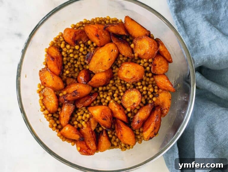 Step 3 Warm roasted carrots added to bowl with lentils before adding parsley and raisins.