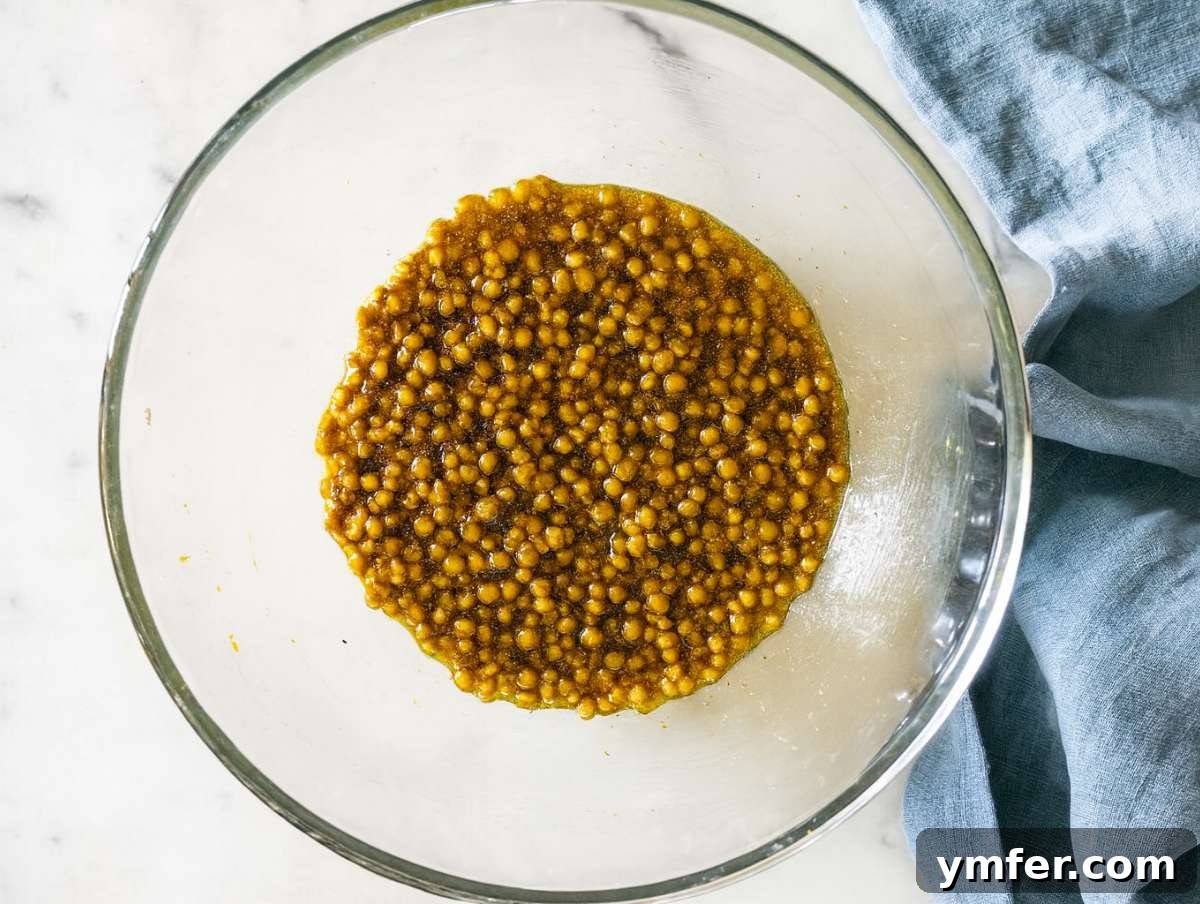 Vibrant Mediterranean Carrot and Lentil Salad 6 Step 2 Lentils tossed in dressing in large bowl ready for mixing.