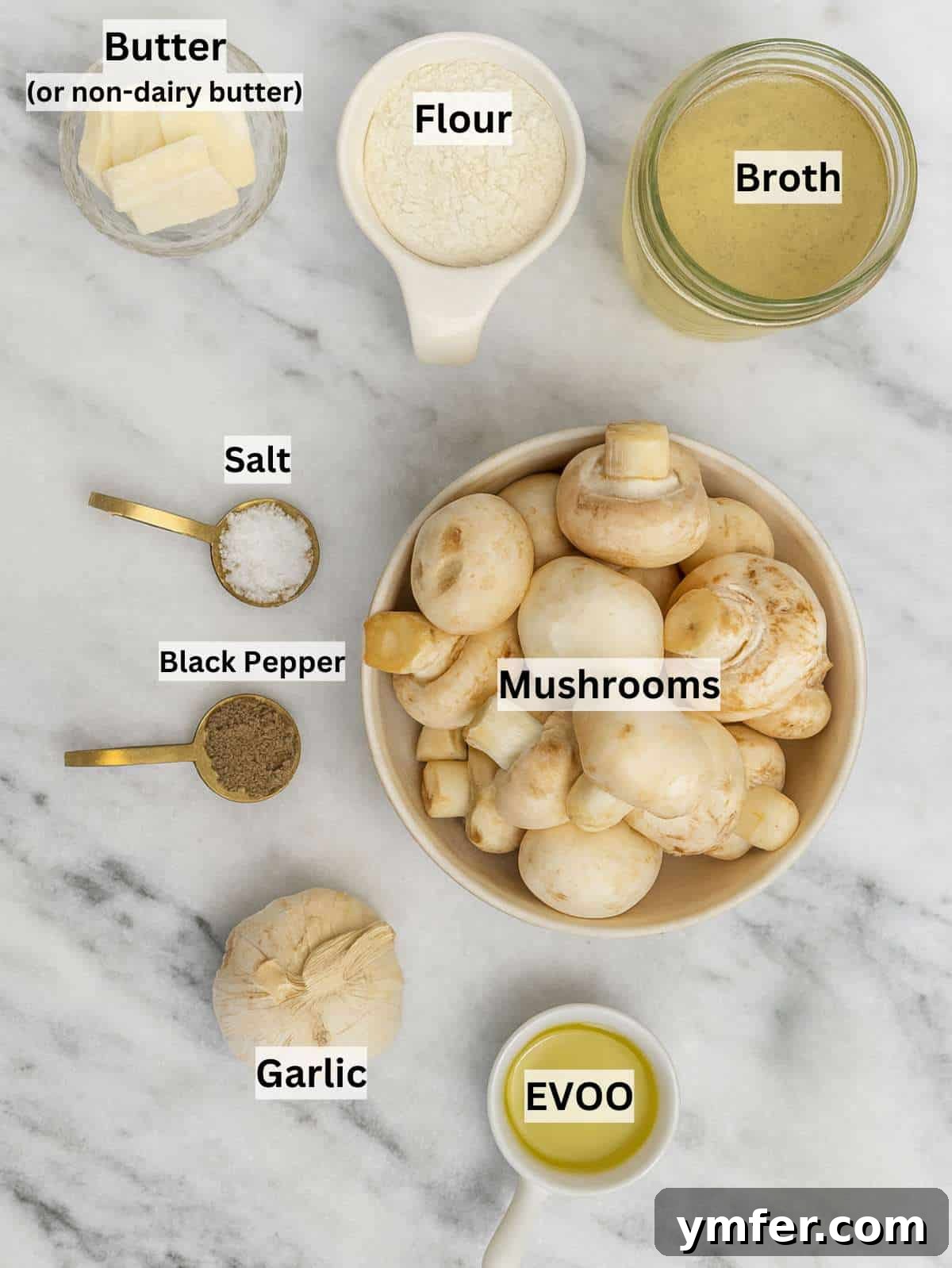 Ingredients for mushroom sauce arranged on table with fresh mushrooms, vegetable broth, and garlic cloves, ready for cooking.