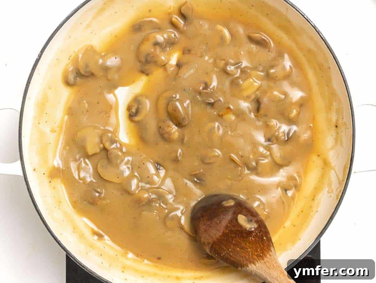Step 4: The freshly made creamy mushroom sauce simmering in a skillet, ready to be served over a comforting meal.