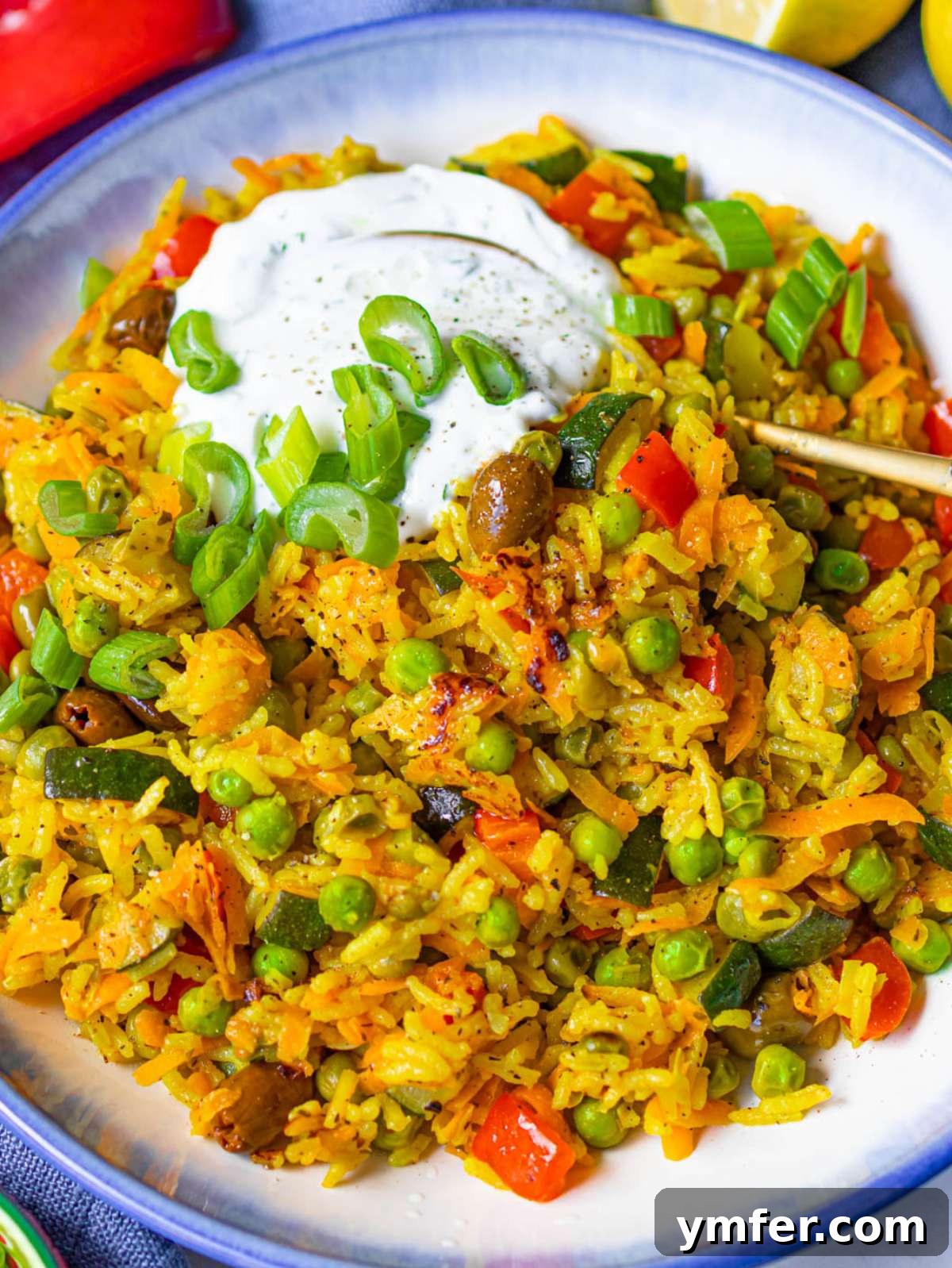 Golden Mediterranean Turmeric Vegetable Skillet 4 Golden Mediterranean stir fry close up with veggies rice turmeric and Greek yogurt topping.